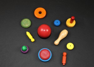 Assorted custom-painted wooden turnings in bright colors made for bulk orders and safety-compliant uses.