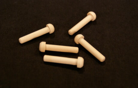 Five custom wooden pegs used in toy vehicles, furniture, and specialty wood products.