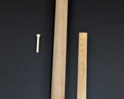 Three unfinished wooden pegs in different sizes, custom turned for toy, furniture, and structural use.