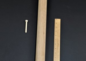 Three unfinished wooden pegs in different sizes, custom turned for toy, furniture, and structural use.