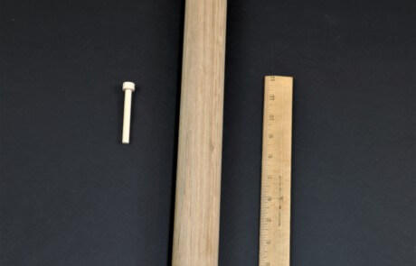 Three unfinished wooden pegs in different sizes, custom turned for toy, furniture, and structural use.