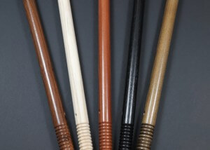 Five wooden police batons with beaded grips in a row, made from finished hardwood.
