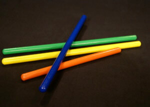 Assorted small wooden dowels in multiple colors, custom finished for bulk orders.