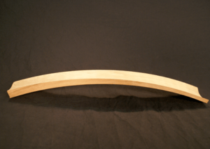Steam bent wood chair part made from cherry with precision CNC routing, shown as a custom furniture component.