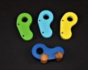 Three custom-shaped wooden toy parts CNC routed from natural hardwood for bulk manufacturing.