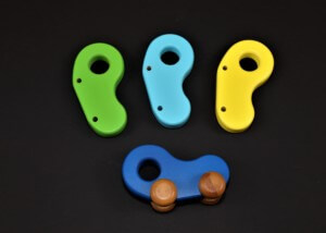 Three custom-shaped wooden toy parts CNC routed from natural hardwood for bulk manufacturing.