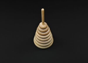 Single turned wooden toy part custom machined for bulk manufacturing applications.