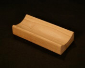 Single piece of small custom wood moulding made from light-colored hardwood for bulk production needs.