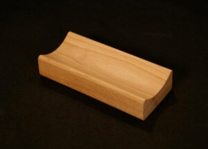 Single piece of small custom wood moulding made from light-colored hardwood for bulk production needs.