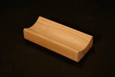 Single piece of small custom wood moulding made from light-colored hardwood for bulk production needs.