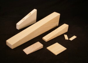 Custom wooden wedges in various sizes for industrial use and specialty manufacturing applications.