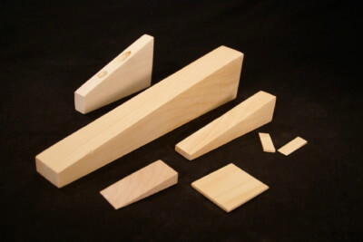 Custom wooden wedges in various sizes for industrial use and specialty manufacturing applications.