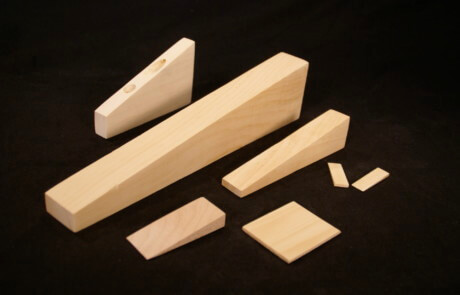 Custom wooden wedges in various sizes for industrial use and specialty manufacturing applications.