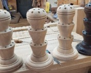 Two custom-turned white oak flag holders replicated from an 1850s design.