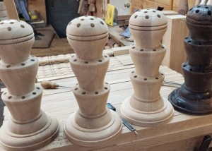Two custom-turned white oak flag holders replicated from an 1850s design.