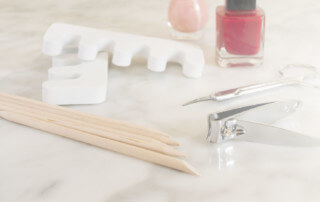 Multiple wood manicure sticks with pointed and beveled ends.