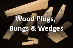Assorted wooden plugs, bungs, and wedges arranged for display on a clean surface.