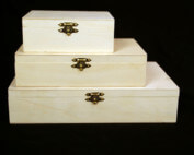 Stack of custom hinged wooden boxes in various sizes made for bulk manufacturing and specialty packaging needs.