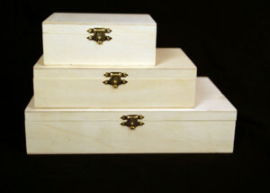 Stack of custom hinged wooden boxes in various sizes made for bulk manufacturing and specialty packaging needs.