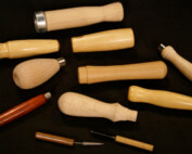 Assorted small wood tool handles in birch and maple with drilled ends and custom finishes.