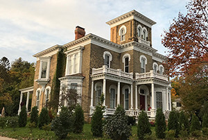 Exterior view of a home with painted wood balusters installed on the porch, supplied by H.A. Stiles and featured in a customer testimonial.