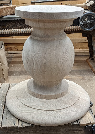 one 27” diameter custom red oak table base