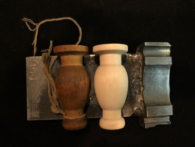 Two custom-turned wood tassels with smooth finishes, designed for decorative or specialty uses.