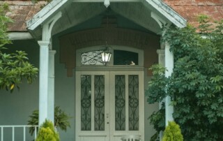 Front view of a house featuring wood porch columns and a front door.